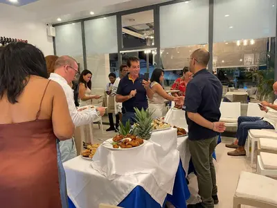 a group of people standing around a table with food at Ristorante simaredo in Punta Cana