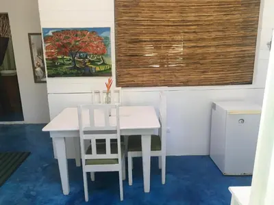a white table and two chairs in a room at Casa Ylang Ylang, Playa Encuentro in Cabarete