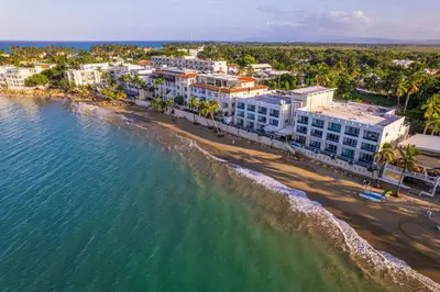 an aerial view of a beach and buildings at Cozy Beach Front Apt, King Bed. in Cabarete