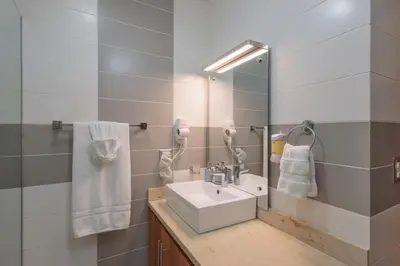 a bathroom with a sink and a mirror at Cozy Beach Front Apt, King Bed. in Cabarete