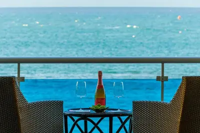 a bottle of wine sitting on a table with two glasses at Cozy Beach Front Apt, King Bed. in Cabarete