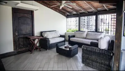 a living room with two chairs and a couch at Penthouse in Santo Domingo