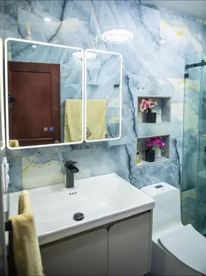 a bathroom with a sink and a mirror and a toilet at Penthouse in Santo Domingo