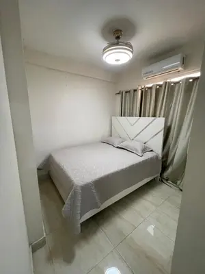 a small bedroom with a bed in a room at Apartamento acoger en Santo Domingo este in Hainamosa