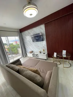 a living room with a couch and a large window at Apartamento acoger en Santo Domingo este in Hainamosa