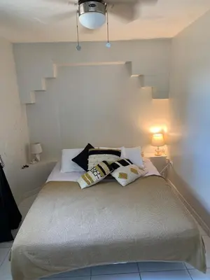 a bedroom with a bed with two pillows on it at Karibisches Familienparadis in Gated Comunity in Sosua