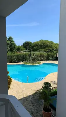 a view of a swimming pool from a balcony at Karibisches Familienparadis in Gated Comunity in Sosua