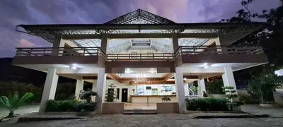 a large house with a large roof at Jarabacoa River Club & Resort in Jarabacoa