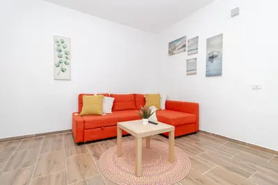 a living room with a red couch and a table at Luxury 1BR Oasis Paraiso Residence Bayahibe
