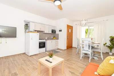 a living room with a kitchen and a table at Luxury 1BR Oasis Paraiso Residence Bayahibe
