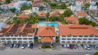 an aerial view of a resort with cars parked in a parking lot at Luxury 1BR Oasis Paraiso Residence Bayahibe