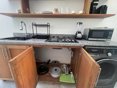 a kitchen with a sink and a washing machine at Beautiful Penthouse in Sunset Puerto Plata Gym, Pool in Puerto Plata