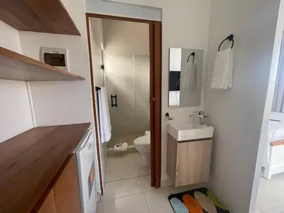 a small bathroom with a toilet and a sink at Beautiful Penthouse in Sunset Puerto Plata Gym, Pool in Puerto Plata