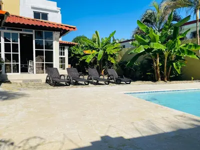 a group of chairs sitting next to a swimming pool at 360 View House with Private Pool Jacuzzi and Terrace in Puerto Plata