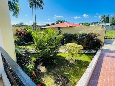 a view of a garden from the balcony of a house at 360 View House with Private Pool Jacuzzi and Terrace in Puerto Plata