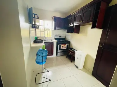 a small kitchen with a blue container on the floor at 360 View House with Private Pool Jacuzzi and Terrace in Puerto Plata