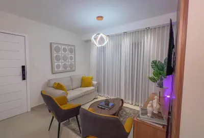 a living room with a couch and a table at San Isidro Urban suite in Juan López