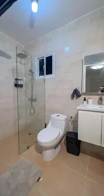a bathroom with a toilet and a shower and a sink at San Isidro Urban suite in Juan López