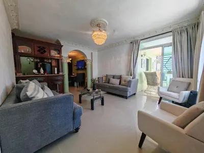 a large living room with couches and chairs at 3 Bed, 2 Bath, Hot Water, Apartment near the beach, in Bani in Baní