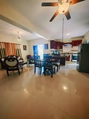 a living room with chairs and a ceiling fan at Cozy apartment, AC, Wifi, 2 Bedroom, 2 bath, Bani, 1-A in Baní