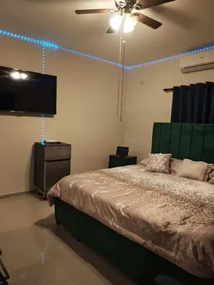 a bedroom with a bed and a ceiling fan at Cozy apartment, AC, Wifi, 2 Bedroom, 2 bath, Bani, 1-A in Baní