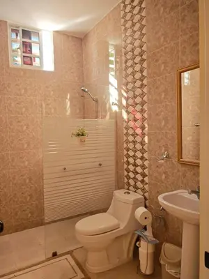 a bathroom with a toilet and a sink at Cozy apartment, AC, Wifi, 2 Bedroom, 2 bath, Bani, 1-A in Baní