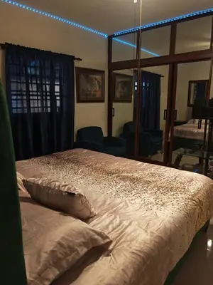 a bedroom with a large bed with lights on it at Cozy apartment, AC, Wifi, 2 Bedroom, 2 bath, Bani, 1-A in Baní
