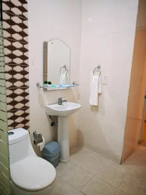 a bathroom with a sink and a toilet and a mirror at Cozy apartment, AC, Wifi, 2 Bedroom, 2 bath, Bani, 1-A in Baní