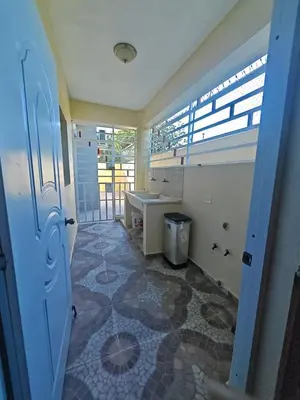 a room with a bathroom with a sink and a window at Cozy apartment, AC, Wifi, 2BR, 2Bath, Bani, 1-B in Baní