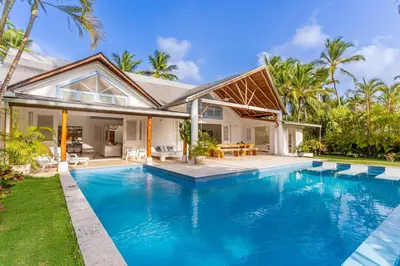 a villa with a swimming pool in front of a house at Las Marinas Los Nmada, 80 meters from Coson beach in Las Terrenas