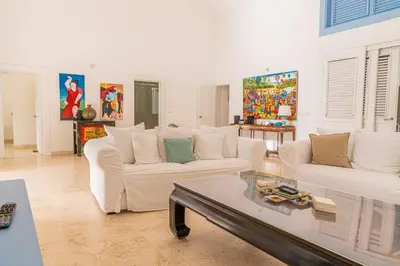 a living room with two white couches and a coffee table at Las Marinas Los Nmada, 80 meters from Coson beach in Las Terrenas