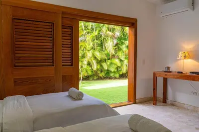 a bedroom with two beds and a large window at Las Marinas Los Nmada, 80 meters from Coson beach in Las Terrenas