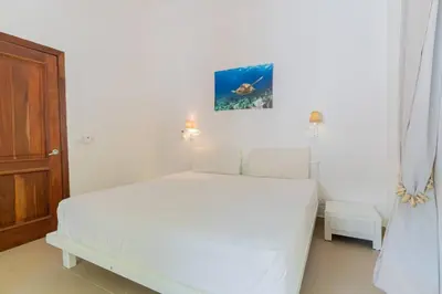 a white bedroom with a white bed in a room at Tropical Villa in Playa Bonita in Pasos Del Mar in Las Terrenas