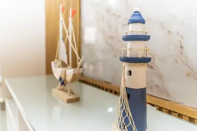 a blue and white lighthouse toy on a table at Caribey 200 meters from Punta Popy beach in Las Terrenas