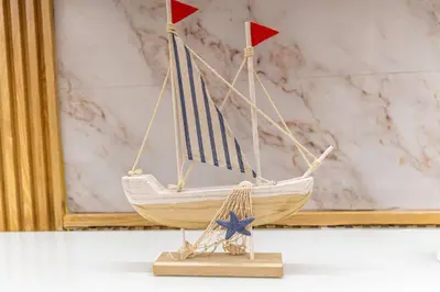 a wooden model of a boat with a blue stripe at Caribey 200 meters from Punta Popy beach in Las Terrenas