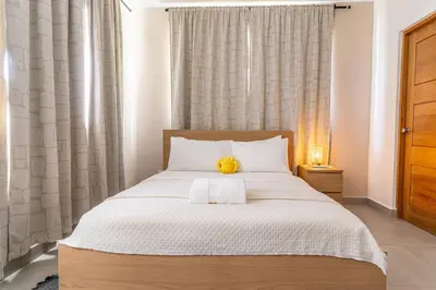 a bedroom with a bed with a teddy bear on it at Caribey 200 meters from Punta Popy beach in Las Terrenas