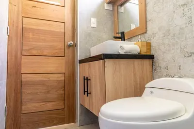 a bathroom with a toilet and a sink at Caribey 200 meters from Punta Popy beach in Las Terrenas