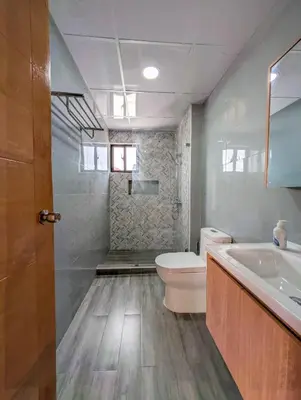 a bathroom with a toilet and a tub and a sink at Prado Garden Hotel in Monte Plata