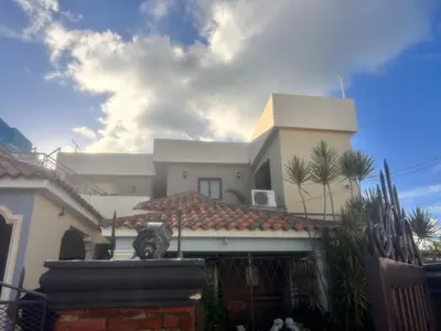 a large white house with a roof at El descanso in Mata Chalupe