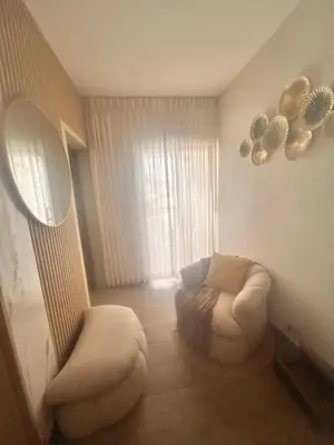 a living room with a couch and a chair and a mirror at El descanso in Mata Chalupe