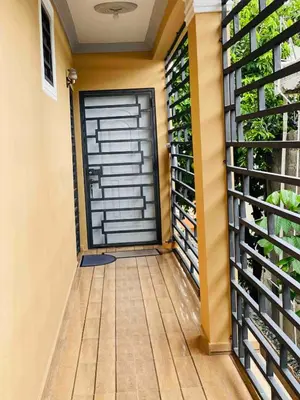 a garage door in a house with a balcony at Stylish Apartment Steps from Puerto Plata Malecon in San Felipe de Puerto Plata