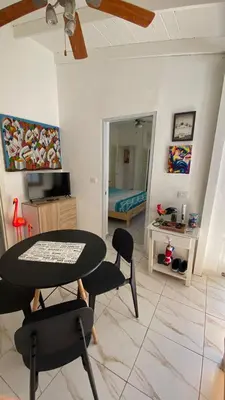 a living room with a table and chairs and a bedroom at Casa Mattia in La Laguna