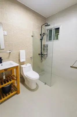 a bathroom with a toilet and a glass shower at Boca chica playa y sol in Boca Chica