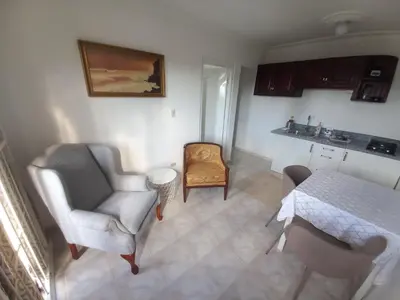 a living room with two chairs and a table at Casa Petter og Maria first floor in Santiago de los Caballeros