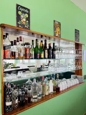 a shelf filled with lots of bottles of alcohol at Hotel La Loma in Miches