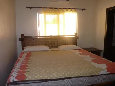 a bedroom with a large bed with a window at Villa near the beach in Cabarete