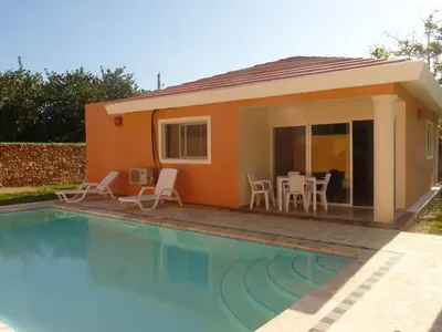 a house with a swimming pool in front of it at Villa near the beach in Cabarete