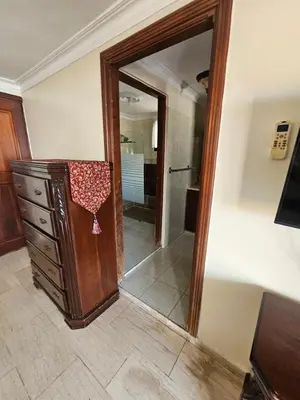 a mirror in a room with a dresser and a bathroom at Villa Mila en Santo Domingo in Los Tres Ojos de Agua