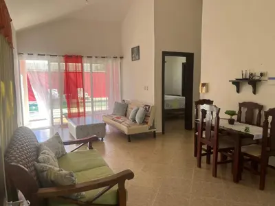 a living room with a couch and a table and chairs at Villa amalu in Cabarete