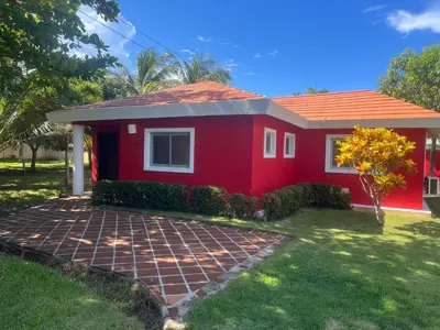 a red house with a red roof at Villa amalu in Cabarete
